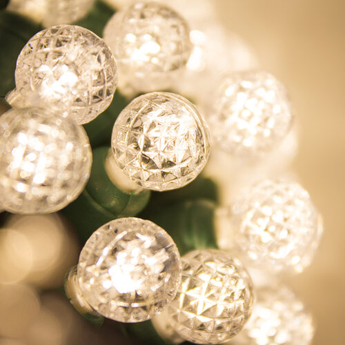 70 G12 Warm White LED String Lights, Green Wire, 4" Spacing